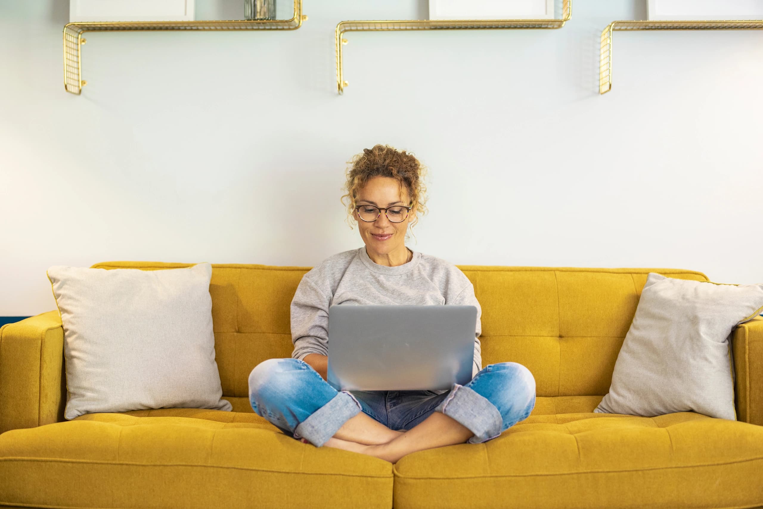 Woman working on laptop on couch